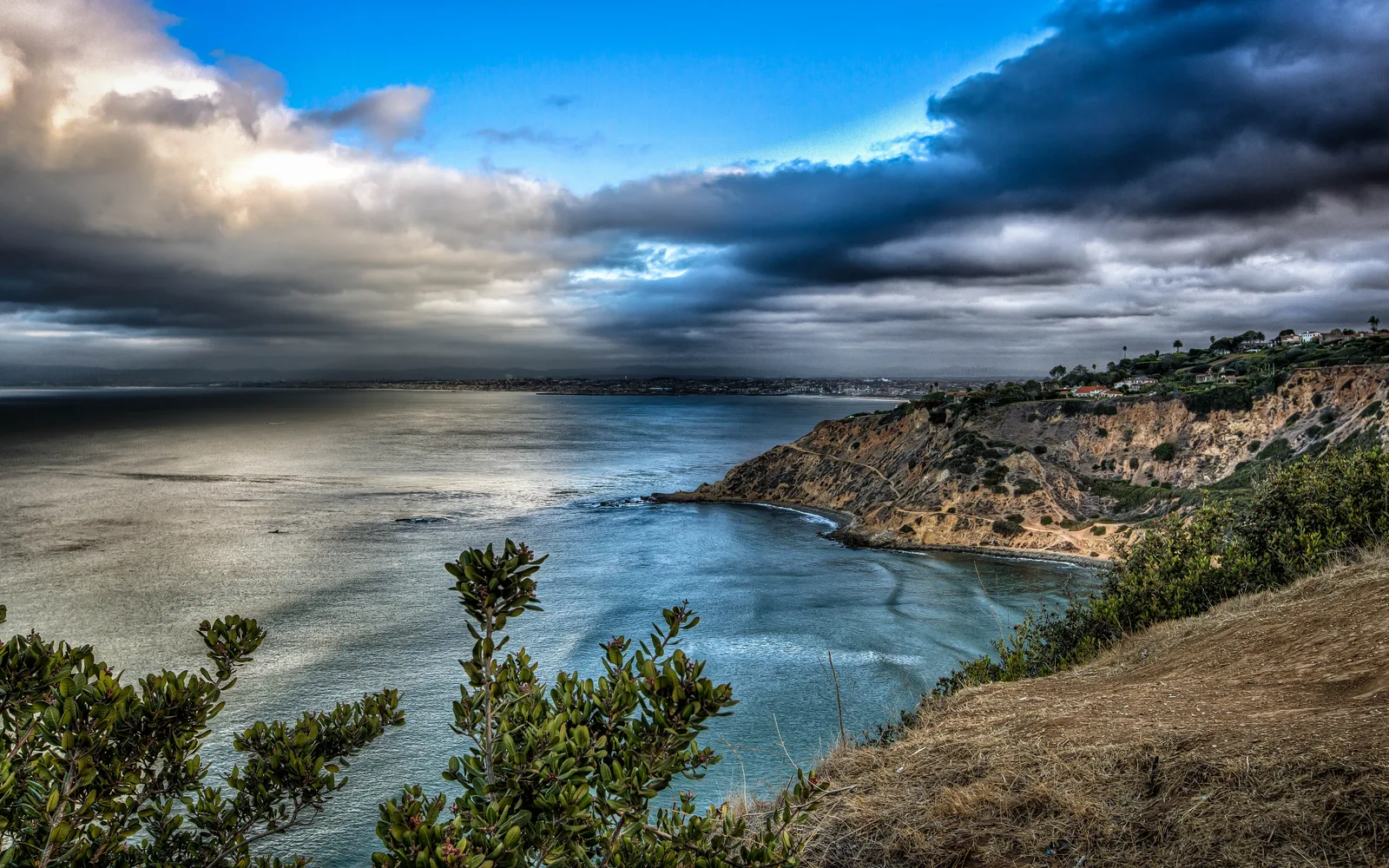 Seascape view of Rancho Palos Verdes coastal bluffs overlooking the Pacific Ocean with horizon line